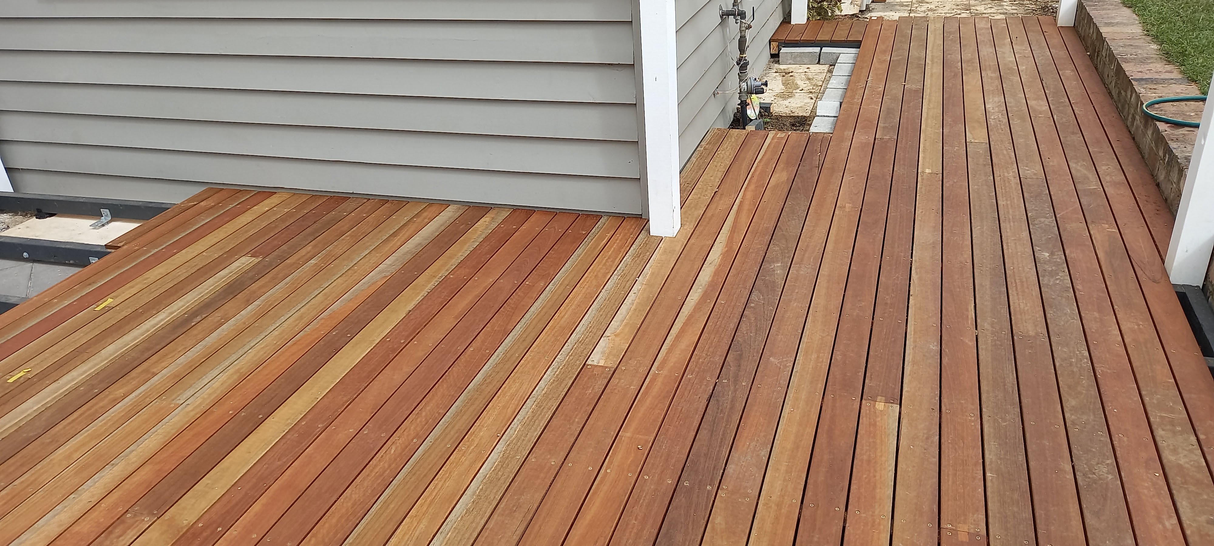 Merbau timber decking boards laid around the corner of a house